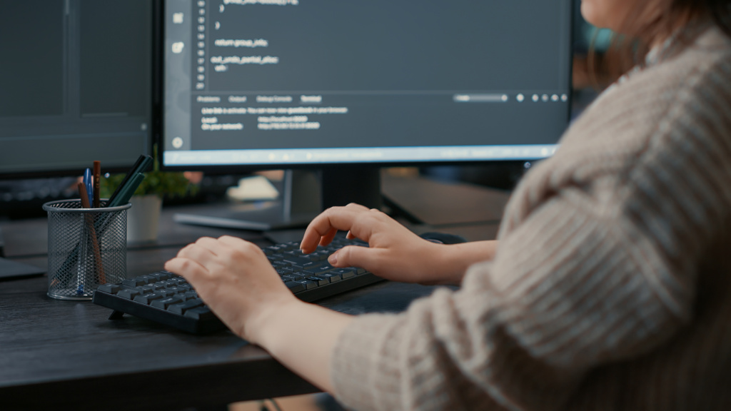 closeup-caucasian-software-coder-hands-typing-keyboard-front-computer-screens-with-programming-interface-database-developer-sitting-desk-writing-algorithm-it-agency.jpg